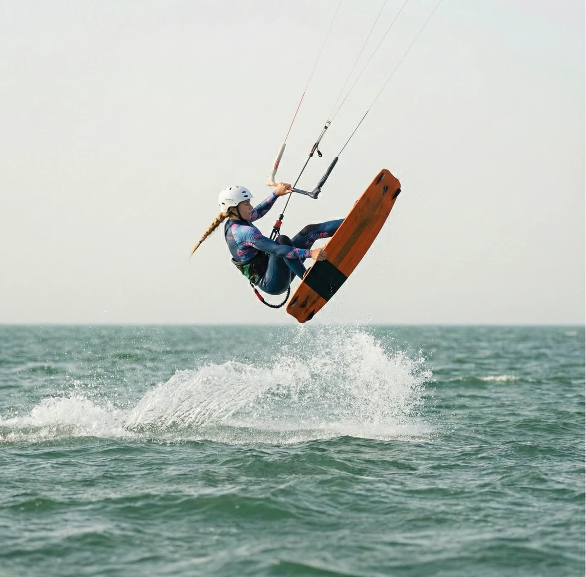 Female kitesurfer mid-air