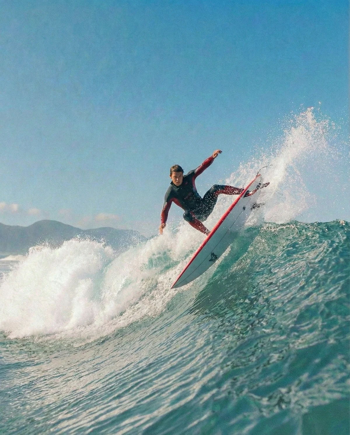 Male surfer ripping a top turn, big spray